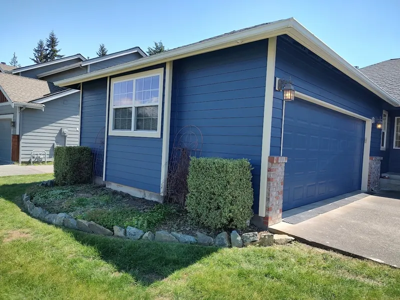 Blue house and garage door with cream trim