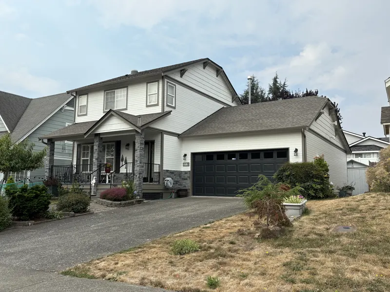 Two-story house with white siding and dark gray trim